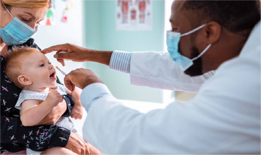 Image of a mother with baby sitting on her lap and a doctor performing a health check up to the baby.