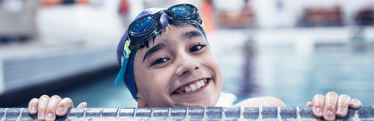 Image of a healthy, smiling child in a swimming pool